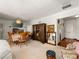 Traditional dining room with wooden table and chairs, vintage cabinet, and a glimpse of the entryway at 1704 S 8Th St, Las Vegas, NV 89104