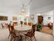 Spacious dining room with wooden chairs around a large table, decorative lighting, and open access to other rooms at 1704 S 8Th St, Las Vegas, NV 89104