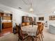 Bright dining area with an ornate table, vintage cabinet, and a view of the kitchen at 1704 S 8Th St, Las Vegas, NV 89104