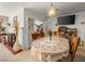 Cozy dining area featuring a lace-covered table, brick fireplace, and a view into the living room at 1704 S 8Th St, Las Vegas, NV 89104