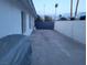 A long driveway leading to a black gate, offering privacy and security, complemented by palm trees adding a touch of desert charm at 1704 S 8Th St, Las Vegas, NV 89104