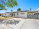 Charming single-story home featuring stucco walls, mature trees and gated access at 1704 S 8Th St, Las Vegas, NV 89104