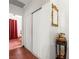 This hallway offers wood floors, a coat closet, and access to the adjacent bathroom at 1704 S 8Th St, Las Vegas, NV 89104