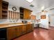 Functional kitchen featuring wooden cabinets, a window above the sink, and a small dining area at 1704 S 8Th St, Las Vegas, NV 89104
