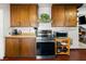 Kitchen with wooden cabinets, stainless steel oven, and a view into the dining room at 1704 S 8Th St, Las Vegas, NV 89104