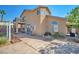 A home's backyard showcases a patio, an upper level balcony, and desert landscaping at 1740 Flores Ln, Henderson, NV 89012