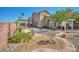 This backyard features a patio with desert landscaping and a pergola at 1740 Flores Ln, Henderson, NV 89012