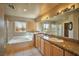Bright bathroom features dual sinks, granite countertops, tub, and separate shower at 1740 Flores Ln, Henderson, NV 89012