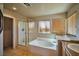 Bright bathroom features a bathtub and a shower with glass doors at 1740 Flores Ln, Henderson, NV 89012