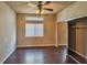 Bright bedroom features hardwood floors, ceiling fan, and a sliding door closet at 1740 Flores Ln, Henderson, NV 89012