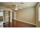 This bedroom offers wood floors, a ceiling fan, a standard closet, and neutral paint at 1740 Flores Ln, Henderson, NV 89012