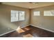 This bedroom features beautiful dark wood floors and large windows for plenty of natural light at 1740 Flores Ln, Henderson, NV 89012