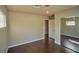 This is a standard bedroom featuring a mirrored closet, wood floors, and neutral paint at 1740 Flores Ln, Henderson, NV 89012