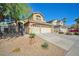 Charming two-story home features a three car garage, desert landscaping and secure wrought iron gate at 1740 Flores Ln, Henderson, NV 89012