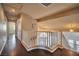 Hallway landing with wood floors and white bannister at 1740 Flores Ln, Henderson, NV 89012
