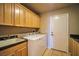 Laundry room boasts ample cabinets, a utility sink, and a modern washer and dryer at 1740 Flores Ln, Henderson, NV 89012