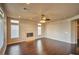 Bright living room boasts hardwood flooring, a cozy fireplace, and large windows at 1740 Flores Ln, Henderson, NV 89012