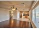 Spacious living room featuring hardwood floors, ceiling fan, and adjoining kitchen area at 1740 Flores Ln, Henderson, NV 89012