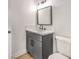Well lit bathroom with gray vanity with marble countertop and large mirror over the sink at 1804 Pacific St, Las Vegas, NV 89104