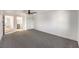 Large primary bedroom boasts plush carpeting, a ceiling fan, and ensuite bath at 1804 Pacific St, Las Vegas, NV 89104
