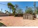 Gravel backyard with a shed, trees and a mix of wood and block fencing at 1825 Howard Ave, Las Vegas, NV 89104