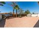 Large gravel backyard featuring a storage shed, trees and wood and block fencing at 1825 Howard Ave, Las Vegas, NV 89104