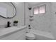 Modern bathroom with marble-look tile, black hardware and accents, and a sleek vanity at 1825 Howard Ave, Las Vegas, NV 89104