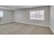 Comfortable bedroom with plush carpeting and a large window at 1825 Howard Ave, Las Vegas, NV 89104