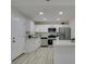 Updated kitchen with stainless appliances, quartz counters, and wood-look floors at 1825 Howard Ave, Las Vegas, NV 89104