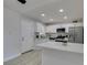 Bright kitchen features stainless appliances, white cabinetry, and breakfast bar at 1825 Howard Ave, Las Vegas, NV 89104