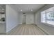Open-concept living space with wood flooring, fresh paint, and easy access to kitchen at 1825 Howard Ave, Las Vegas, NV 89104