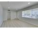 Open-concept living space featuring wood flooring, modern lighting, and fresh paint at 1825 Howard Ave, Las Vegas, NV 89104