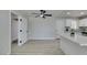 Bright living space with wood flooring, view of kitchen, and modern ceiling fan at 1825 Howard Ave, Las Vegas, NV 89104