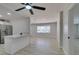 Open living space with wood flooring and view of modern kitchen with white cabinetry at 1825 Howard Ave, Las Vegas, NV 89104