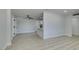 Bright and open floor plan with wood flooring, modern ceiling fan, and access to kitchen at 1825 Howard Ave, Las Vegas, NV 89104