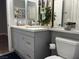 Modern bathroom with a gray vanity, decorative accents, and ample counter space at 1830 N Buffalo Dr # 2022, Las Vegas, NV 89128