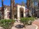 Inviting clubhouse featuring an arched entryway, desert landscaping, and subtle stone accents adding to its welcoming appearance at 1830 N Buffalo Dr # 2022, Las Vegas, NV 89128