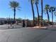 Gated community entrance featuring decorative gates, palm trees, and well-maintained landscaping at 1830 N Buffalo Dr # 2022, Las Vegas, NV 89128