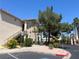 Exterior of condo building featuring stairs, lush landscaping, and assigned handicap parking at 1830 N Buffalo Dr # 2022, Las Vegas, NV 89128