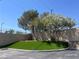 Landscaped green space and beautiful foliage offering a tranquil setting next to a sound-reducing privacy wall at 1830 N Buffalo Dr # 2022, Las Vegas, NV 89128