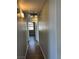 Hallway with wood-look flooring, leading to other rooms in the home at 1830 N Buffalo Dr # 2022, Las Vegas, NV 89128