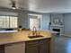 Kitchen with granite counters overlooking the dining area and living room with a fireplace at 1830 N Buffalo Dr # 2022, Las Vegas, NV 89128