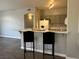 A cozy kitchen and eat in bar area featuring gray cabinetry and modern appliances at 1830 N Buffalo Dr # 2022, Las Vegas, NV 89128