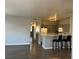 Open concept living area with kitchen featuring breakfast bar and updated appliances at 1830 N Buffalo Dr # 2022, Las Vegas, NV 89128