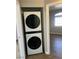 Laundry closet featuring stacked LG washer and dryer appliances, and hallway view at 1830 N Buffalo Dr # 2022, Las Vegas, NV 89128