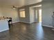 This living room shows hardwood floors, a window, a ceiling fan and the front door open at 1830 N Buffalo Dr # 2022, Las Vegas, NV 89128