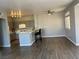 An open concept design with hardwood floors with an eat in kitchen featuring gray cabinetry at 1830 N Buffalo Dr # 2022, Las Vegas, NV 89128