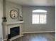 Living room with fireplace, mantel, and a large window allowing natural light to illuminate the space at 1830 N Buffalo Dr # 2022, Las Vegas, NV 89128