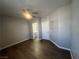 Large main bedroom featuring dark floors, neutral walls, a ceiling fan, and bathroom access at 1830 N Buffalo Dr # 2022, Las Vegas, NV 89128