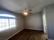 Comfortable main bedroom featuring dark floors, neutral walls, and a well-lit window at 1830 N Buffalo Dr # 2022, Las Vegas, NV 89128